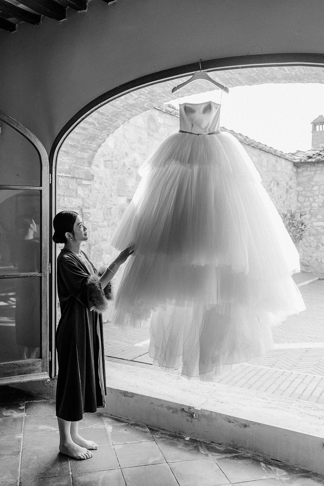 Bride previewing wedding dress before getting ready photoshoot