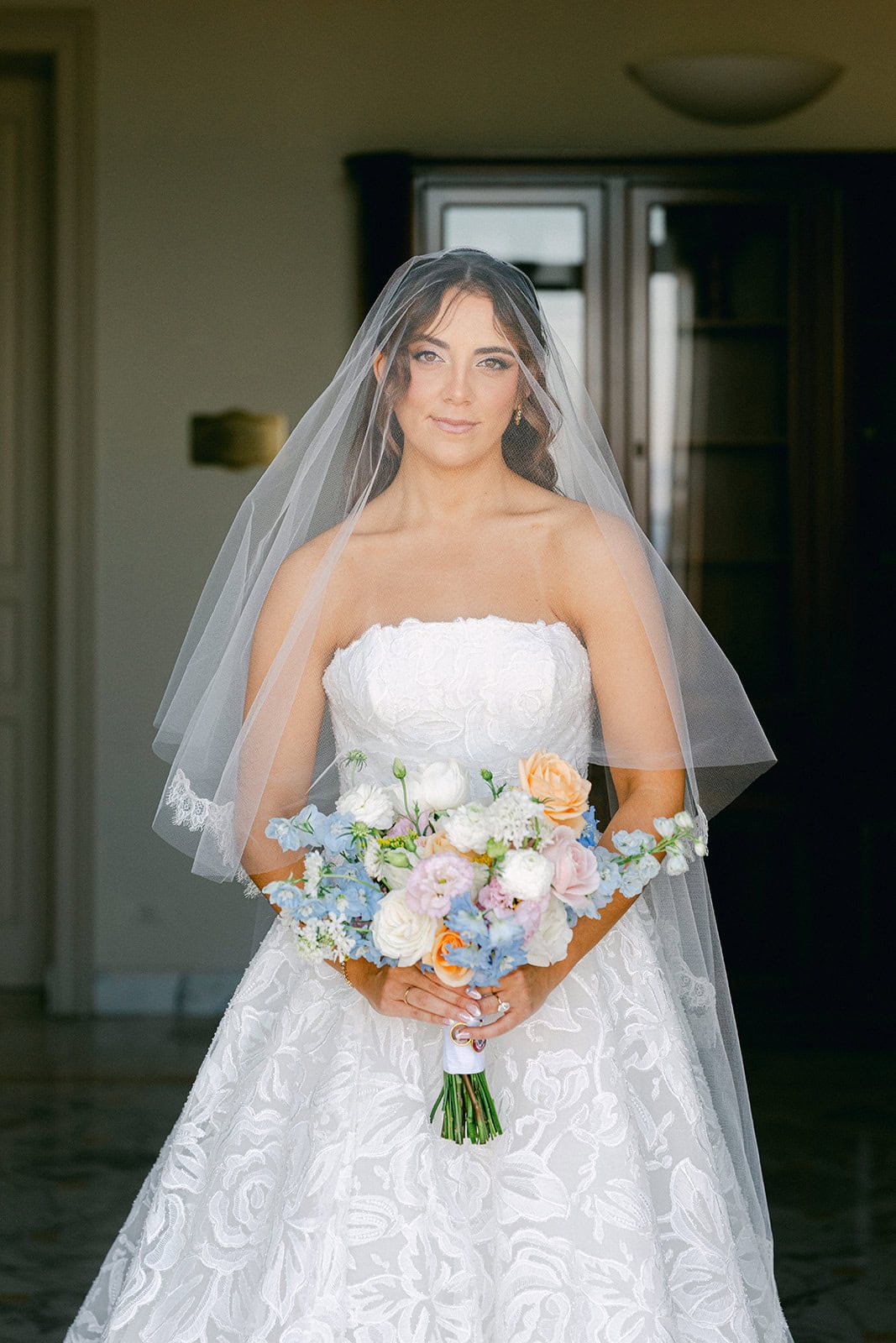 Bride holding bouquet during getting ready pictures wedding moment