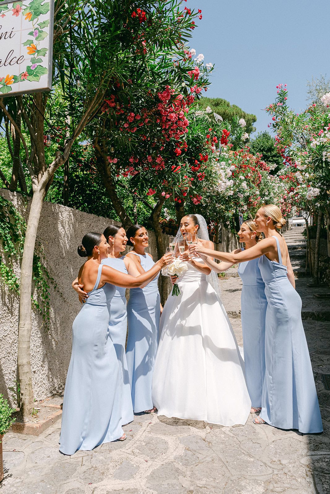 After getting ready wedding bride with champagne toast with bridesmaids