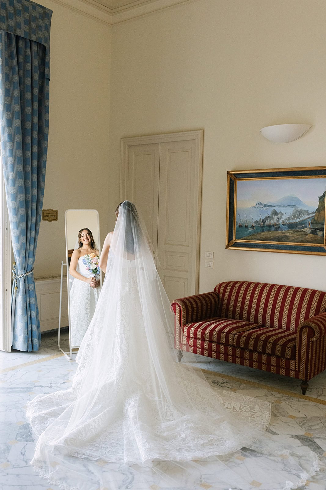 Getting ready pictures wedding bride in mirror with final makeup touches