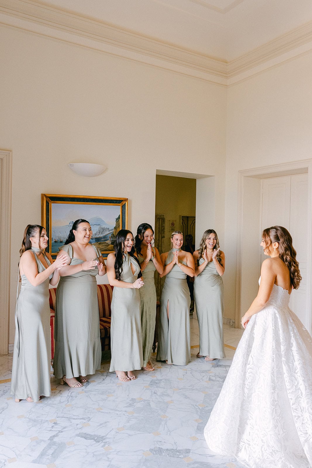 Bridesmaids first look to bride in dress during getting ready pictures wedding