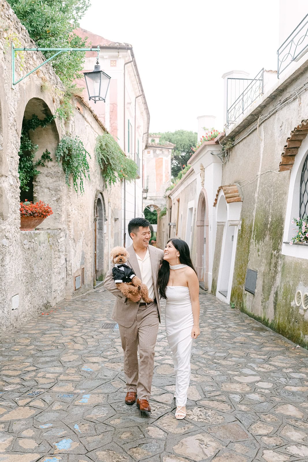 Andrea Gallucci - Destination Wedding Photographer- Amalfi Coast Positano Santorini Barcellona Rome Ravello Paris New York Couple walking with dog during engagement photos in Ravello