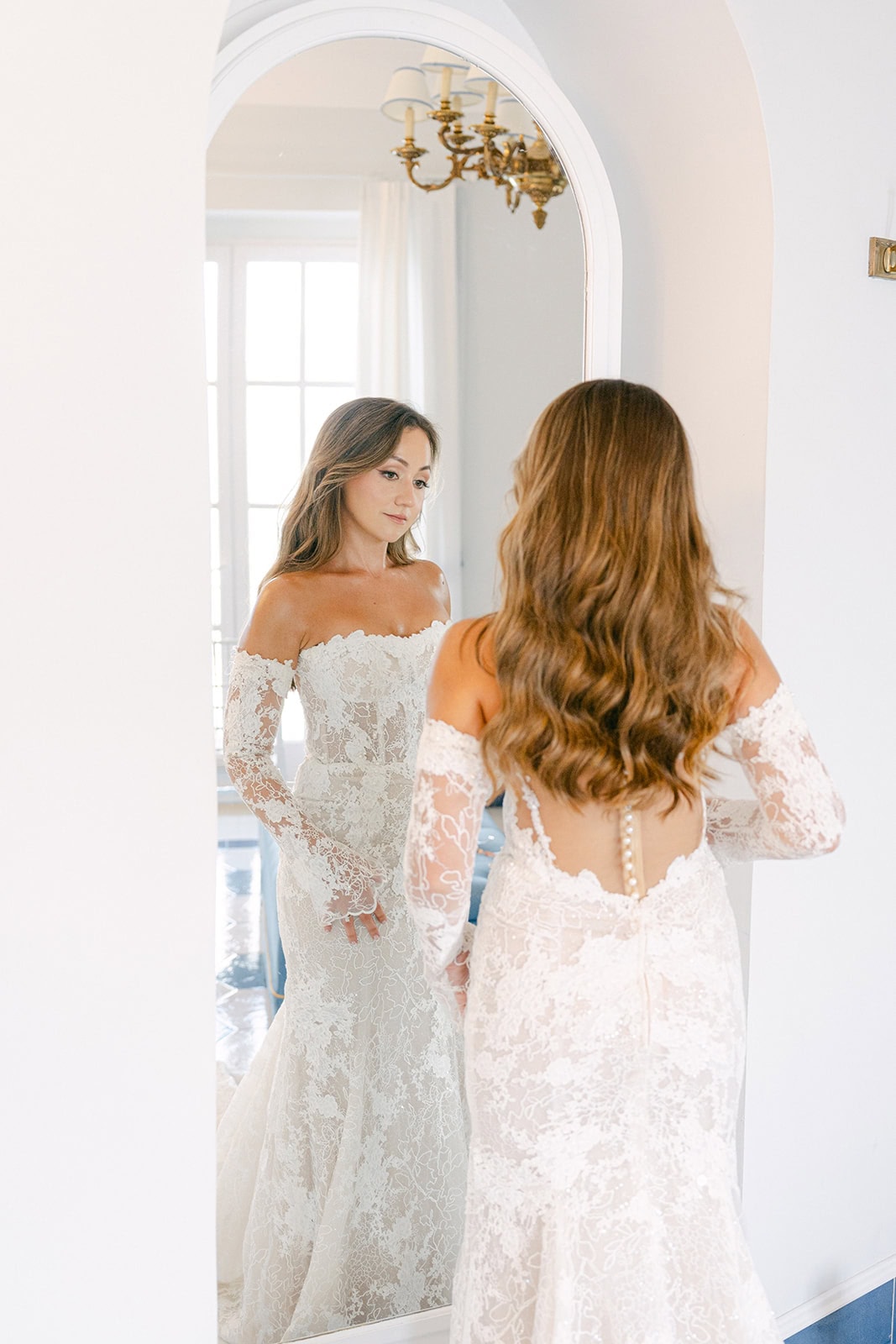 Bride final look mirror moment during wedding getting ready photos