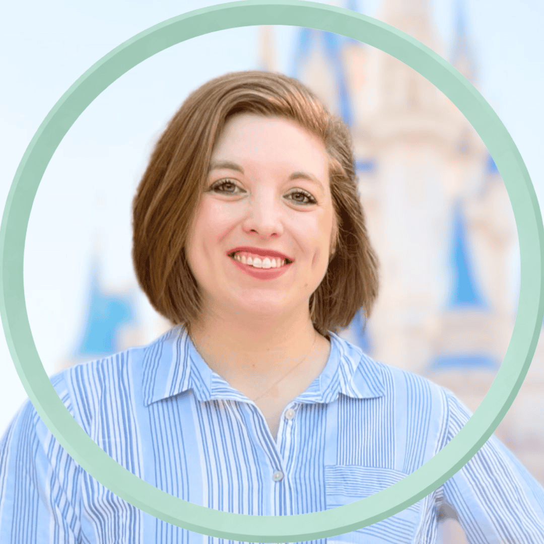 Woman smiling at Disney castle, enjoying a vacation.