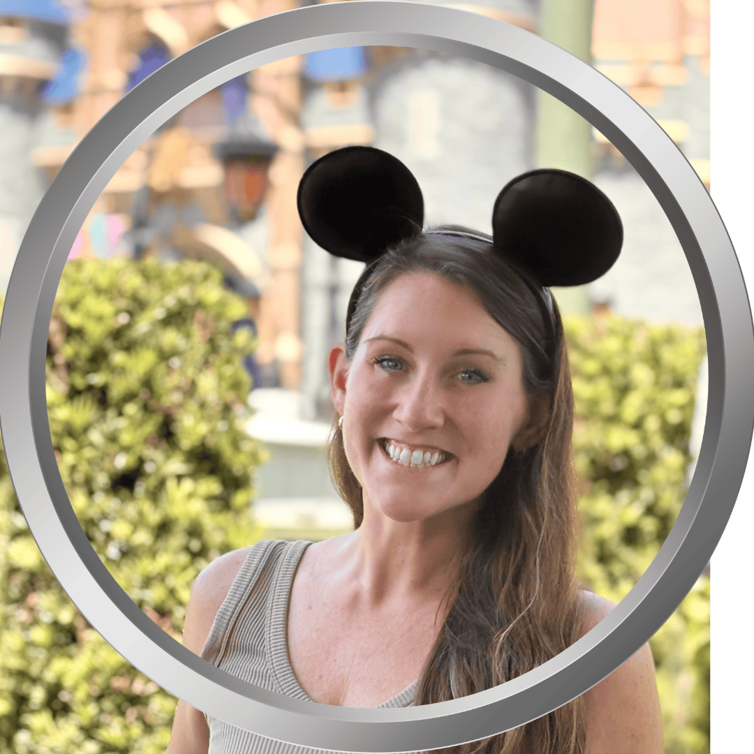 Disney woman with Mickey Mouse ears enjoying a theme park day.