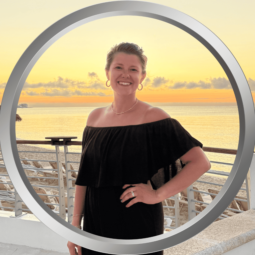 Sunset beach scene featuring ChelseaElder smiling at the camera during a vacation.