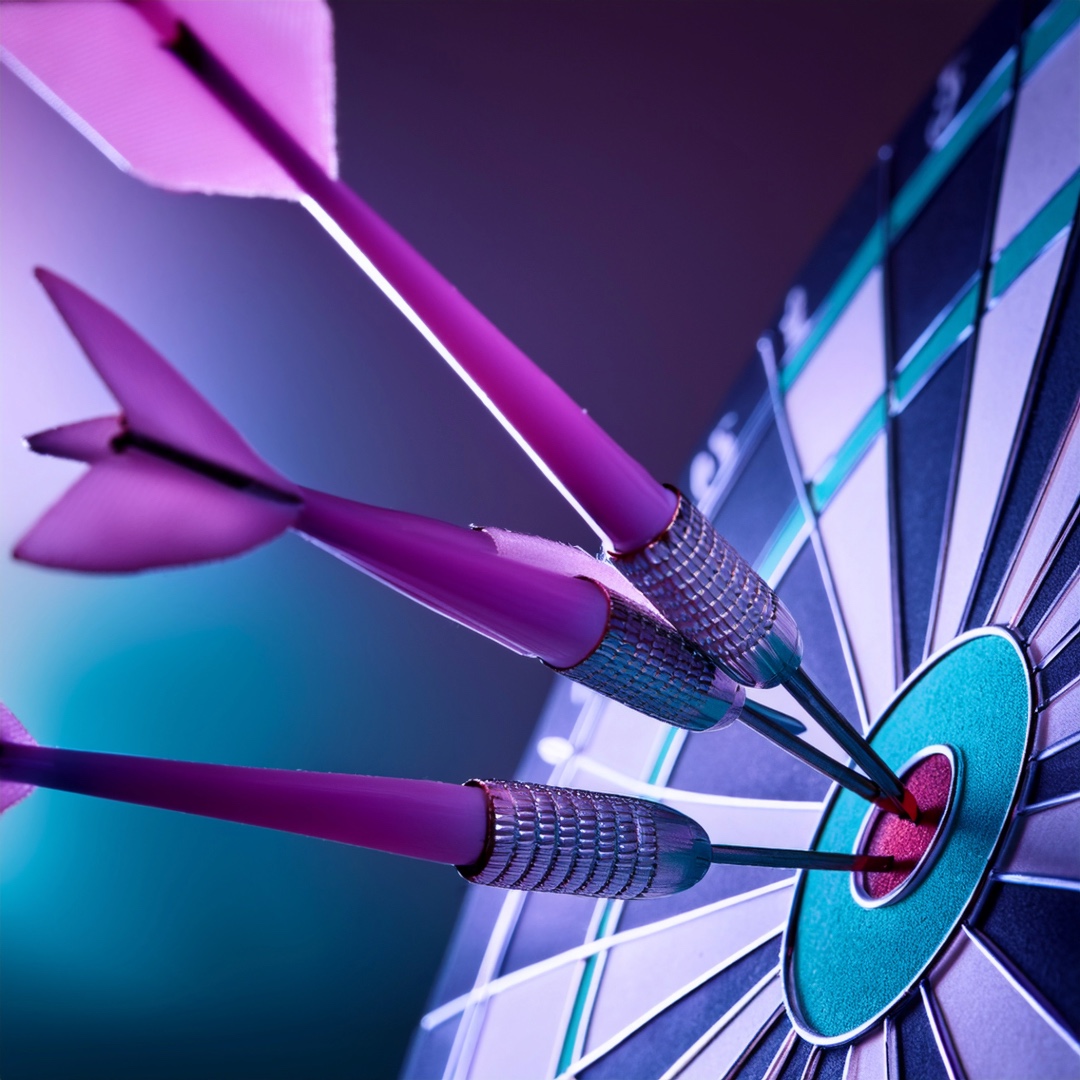 SEO strategy represented by darts on a dartboard hitting bullseye in e purple and teal theme