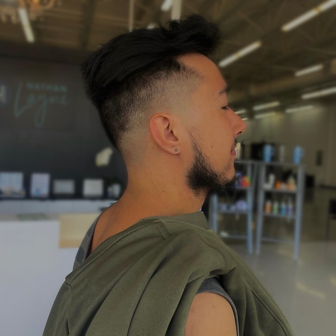 A barber puts lather on a man’s face