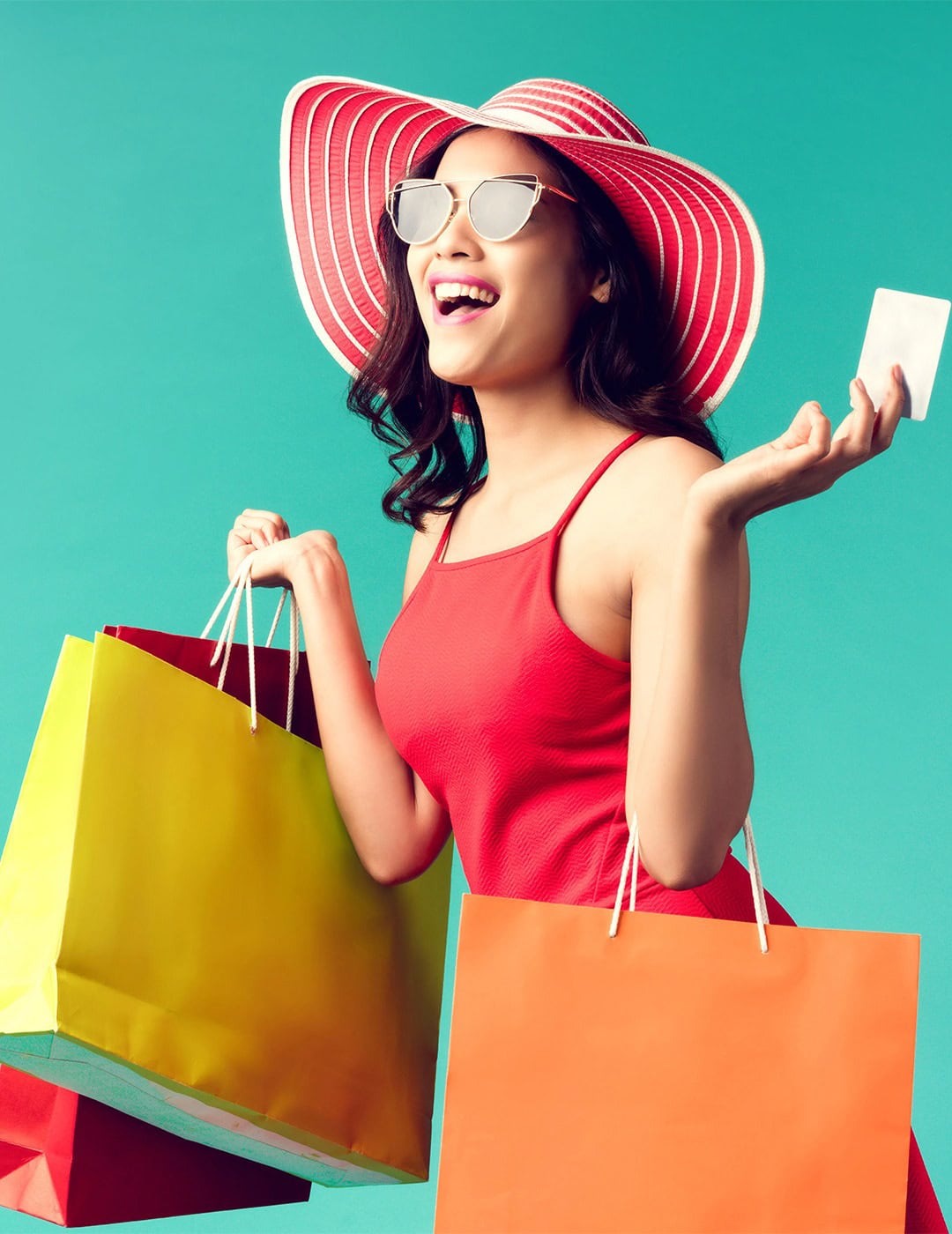 Happy woman shopping with colorful bags – trendy fashion accessories online