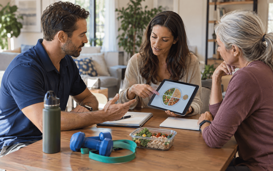 Physical therapist and registered dietitian reviewing a client's nutrition and exercise plan together at a home consultation table