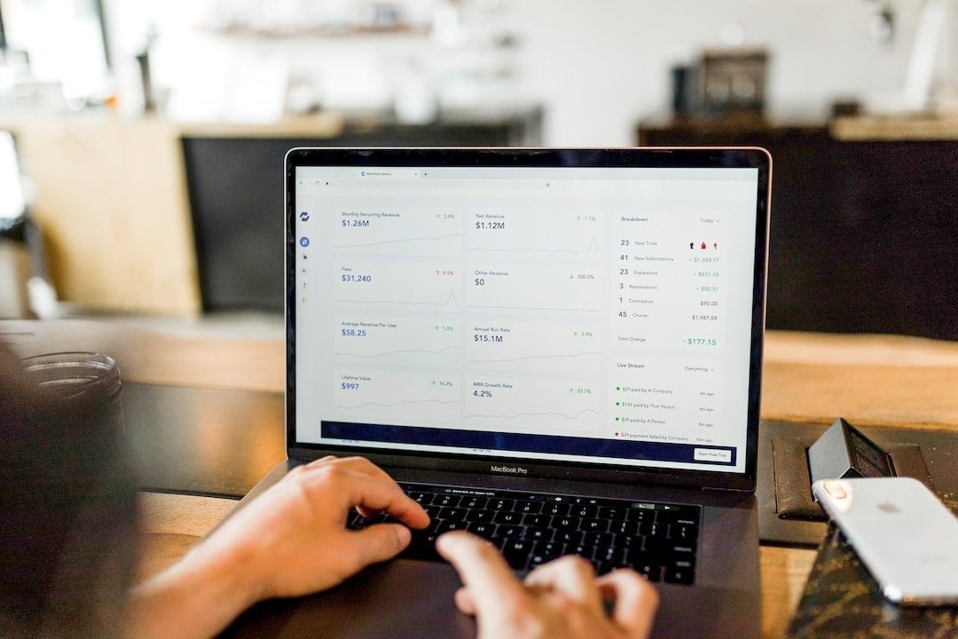 Hands on laptop with finance dashboard - VAT returns processing and data analysis