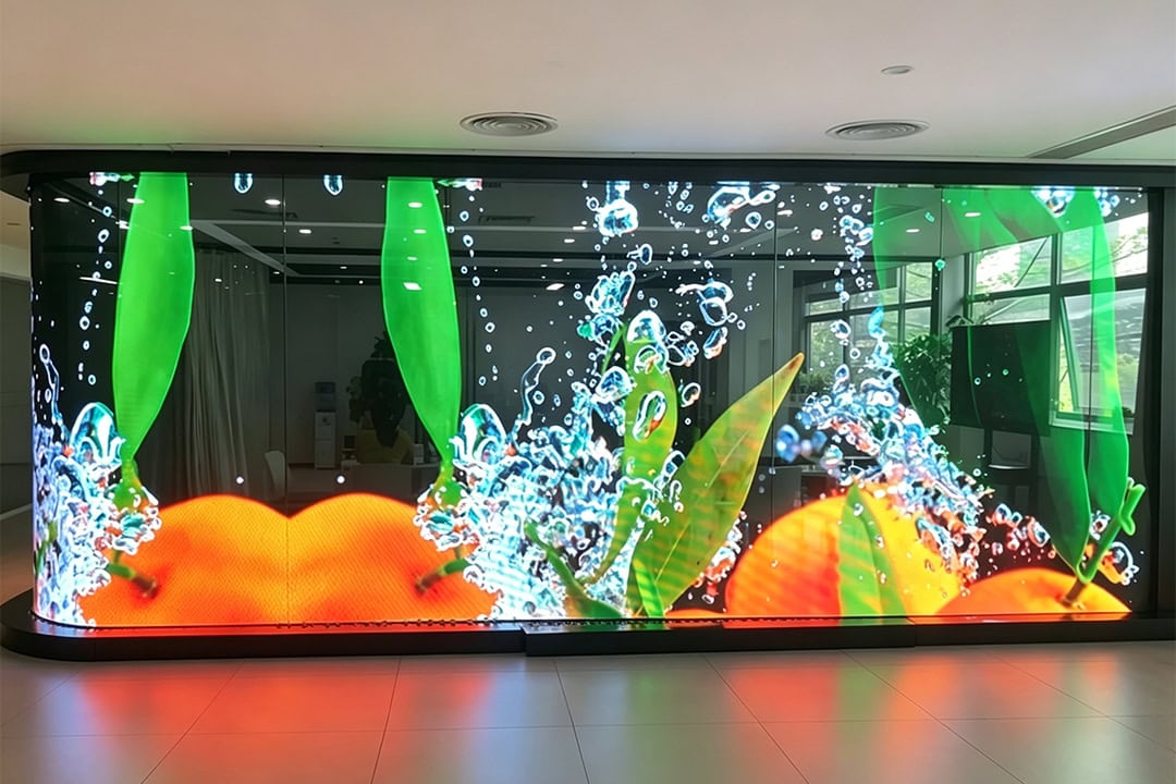 InviAir P2.5 Holographic LED Screen case in Malaysia - high-transparency curved glass display with vibrant fruit and water splash visuals in commercial interior