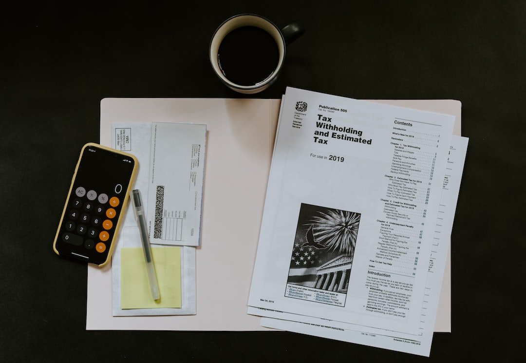 Tax documents, payslip, and phone calculator on desk - payroll and tax calculation concept