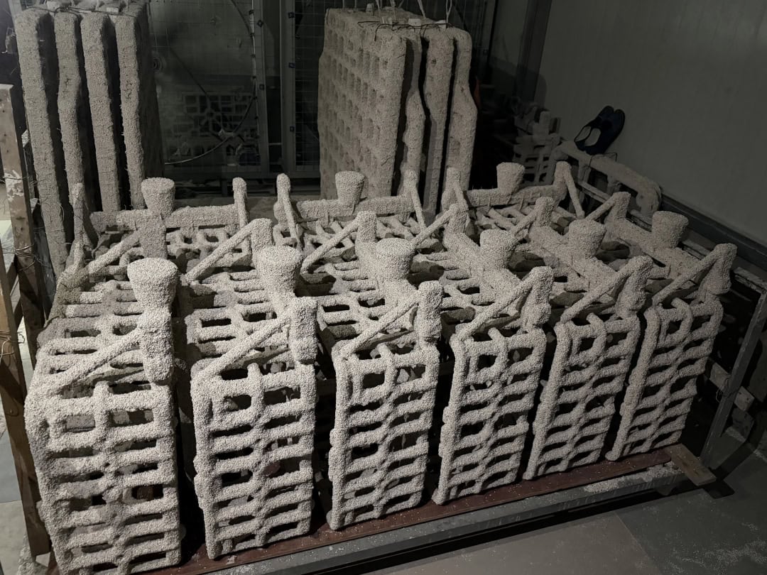 Rows of furnace basket castings with open-grid sides and projecting locating posts