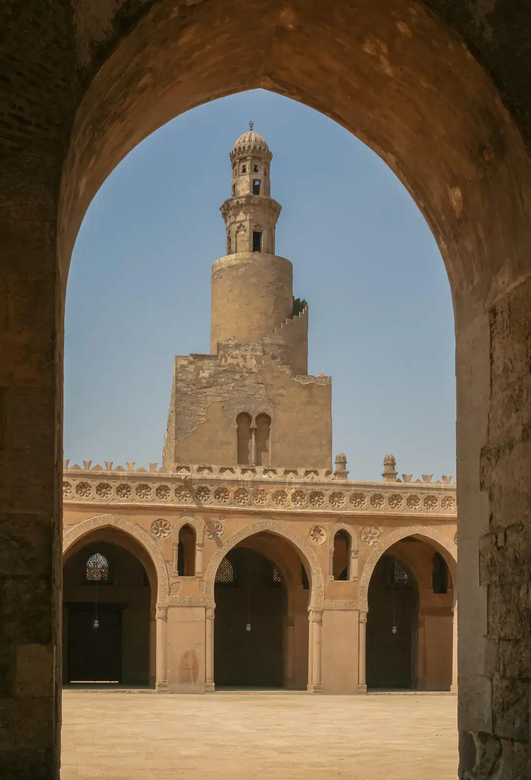 Spiral minaret framed by an arch at Ibn Tulun Mosque