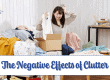 Cluttered room with woman frustrated sorting laundry and clothes, emphasizing the negative effects of clutter on mental health and stress.
