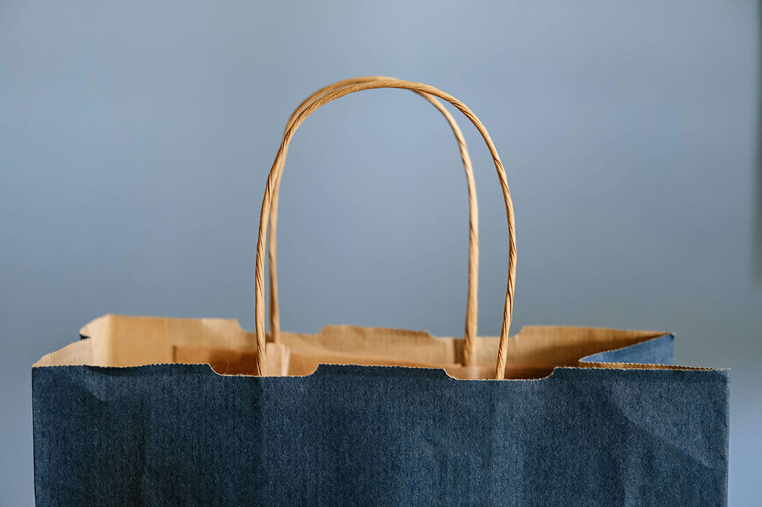 a paper shopping bag on a grey background