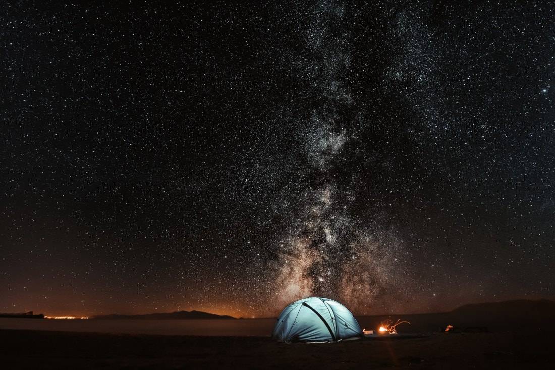 blue tent under the night sky and milky way