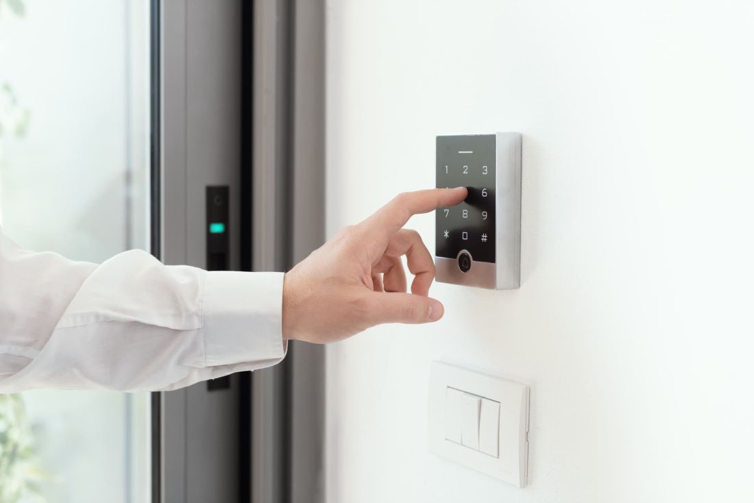 Man setting an alarm code for security, alarm system concept