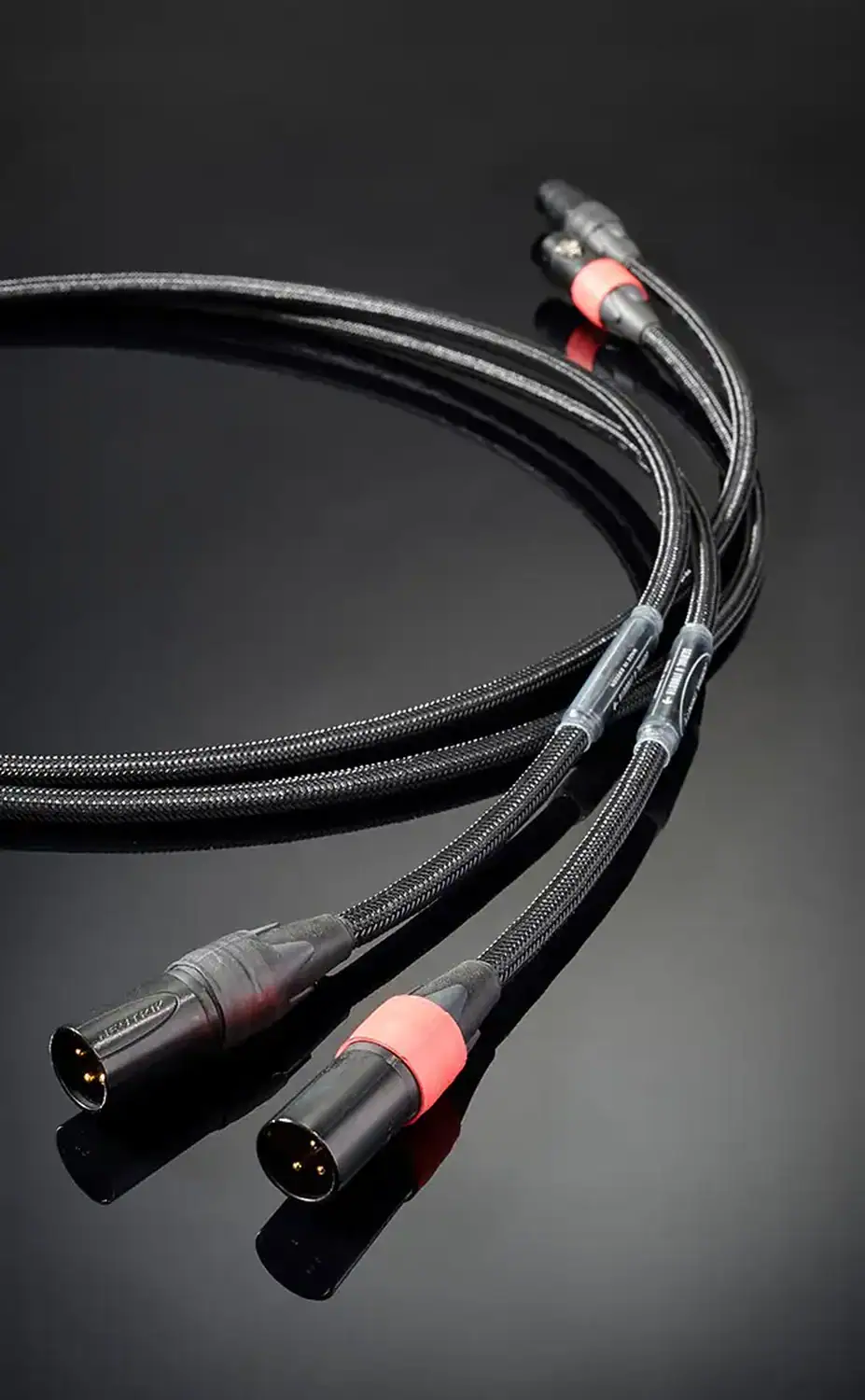 Jorma câble modulation XLR Trinity câbles enroulés sur une surface noire