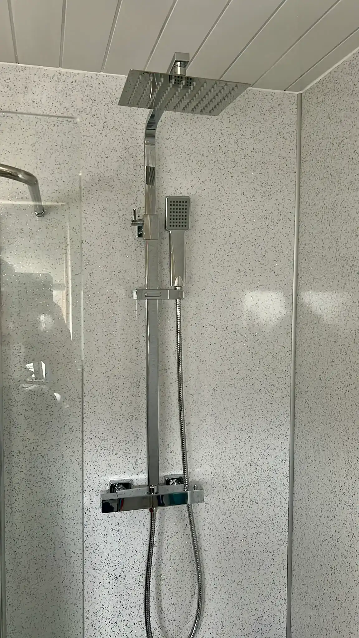 Modern chrome square thermostatic rigid riser rainfall shower system installed by NB Gas & Plumbing in Cumbernauld, Glasgow G67