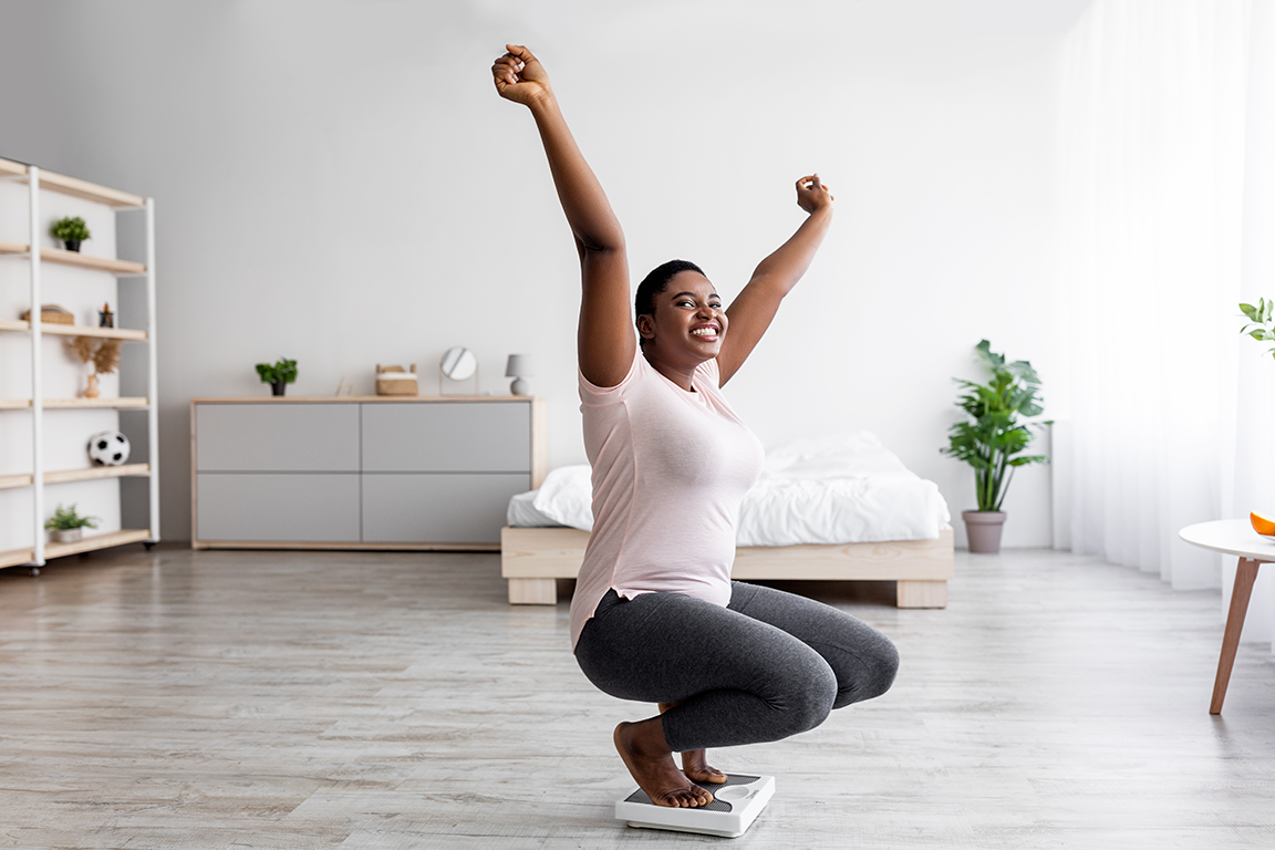 Reaching-Goals woman reaching arms up in air celebrating reaching health goals