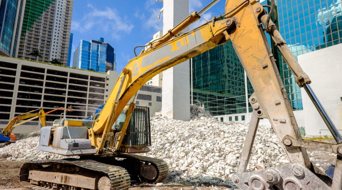 Debris removal from storm-damaged home, heavy equipment clearing rubble