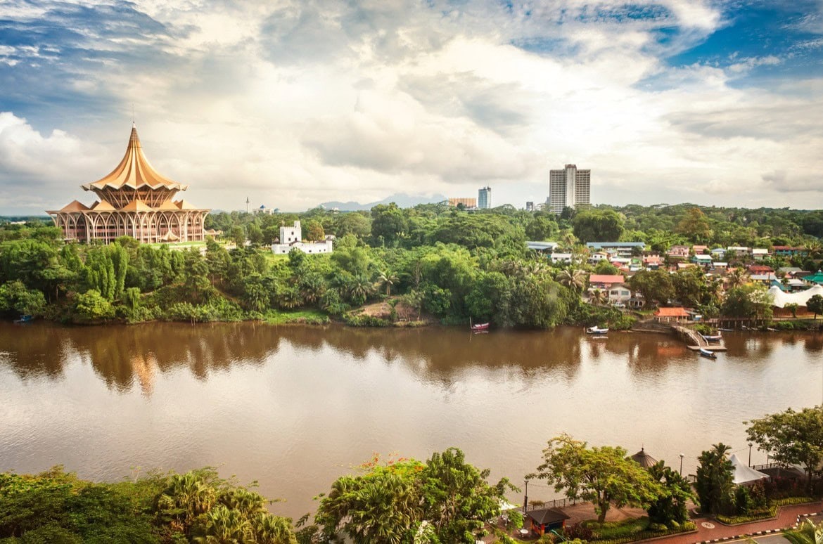 View over the Sarawak River to the north side of the city of Kuching with DUN complex (seat of the Parliament of the Malaysian state of Sarawak) and Fort Margherita, Borneo. Things to do in Kuching, Borneo, Malaysia