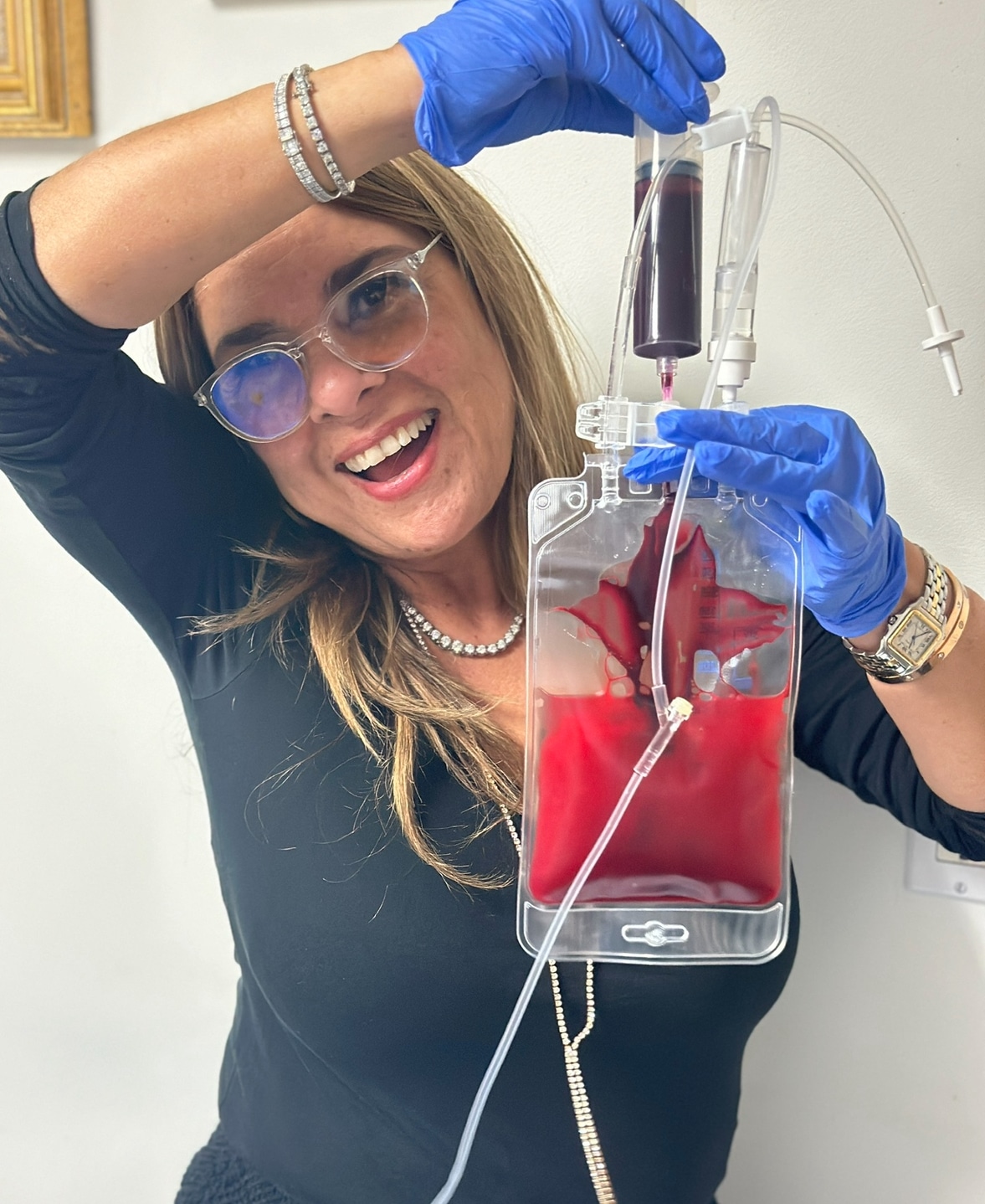 Dr. Iman Bar holding a bag of ozonated blood.