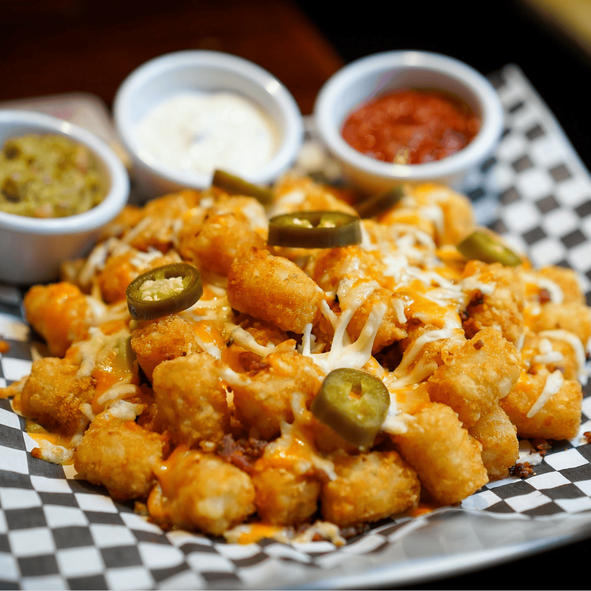 Crispy tater tots loaded with toppings, a delicious appetizer from The Morrissey House, perfect for sharing