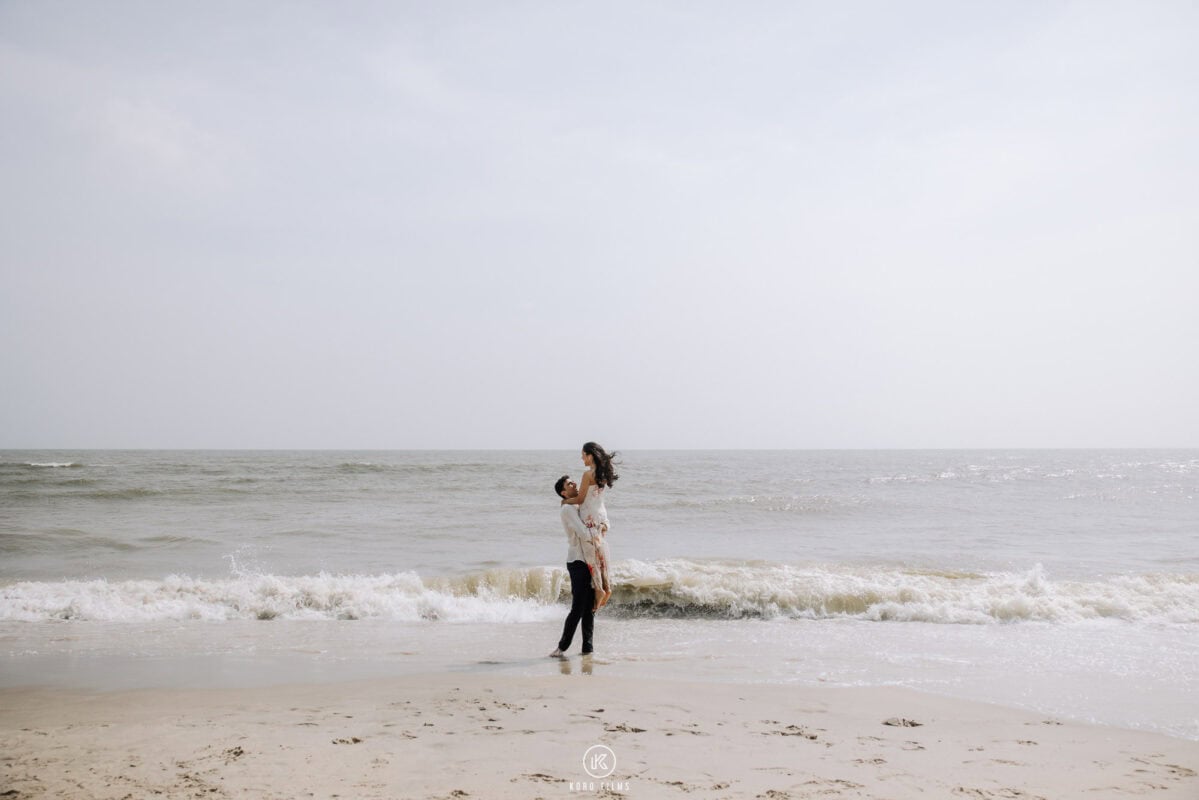 Groom lifts his bride on the beach as waves roll in, pre-wedding shoot at Sheraton Hua Hin Resort & Spa