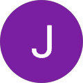 A white letter "J" centered on a solid purple circular background.