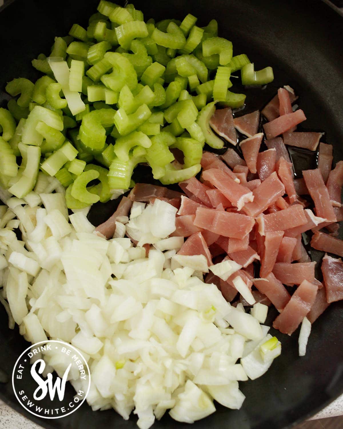 celery, bacon and onion in a pan
