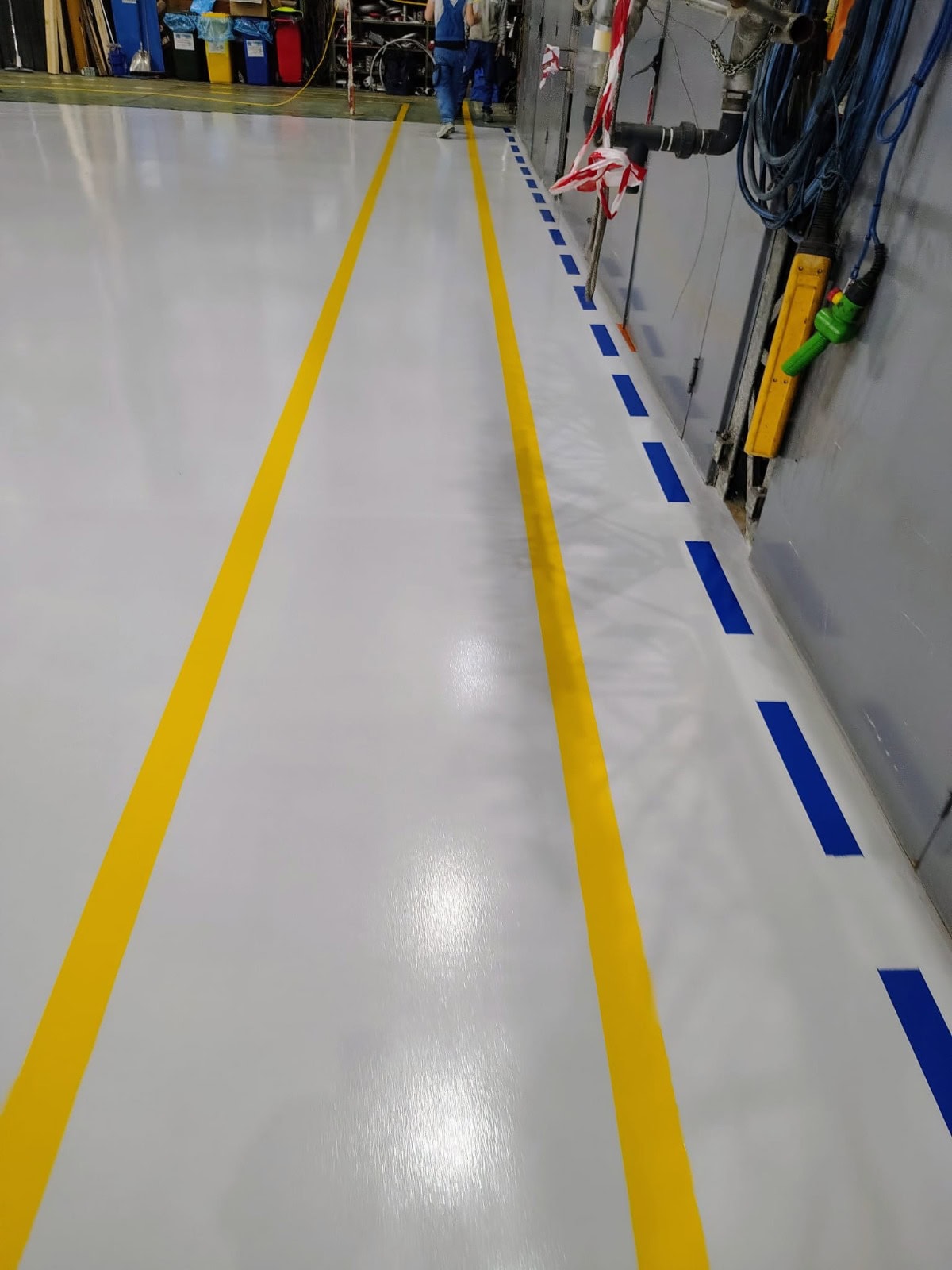 Pavimento industriale verniciato con finitura Polilux lucida RAL 0632, area produzione apparecchiature elettriche