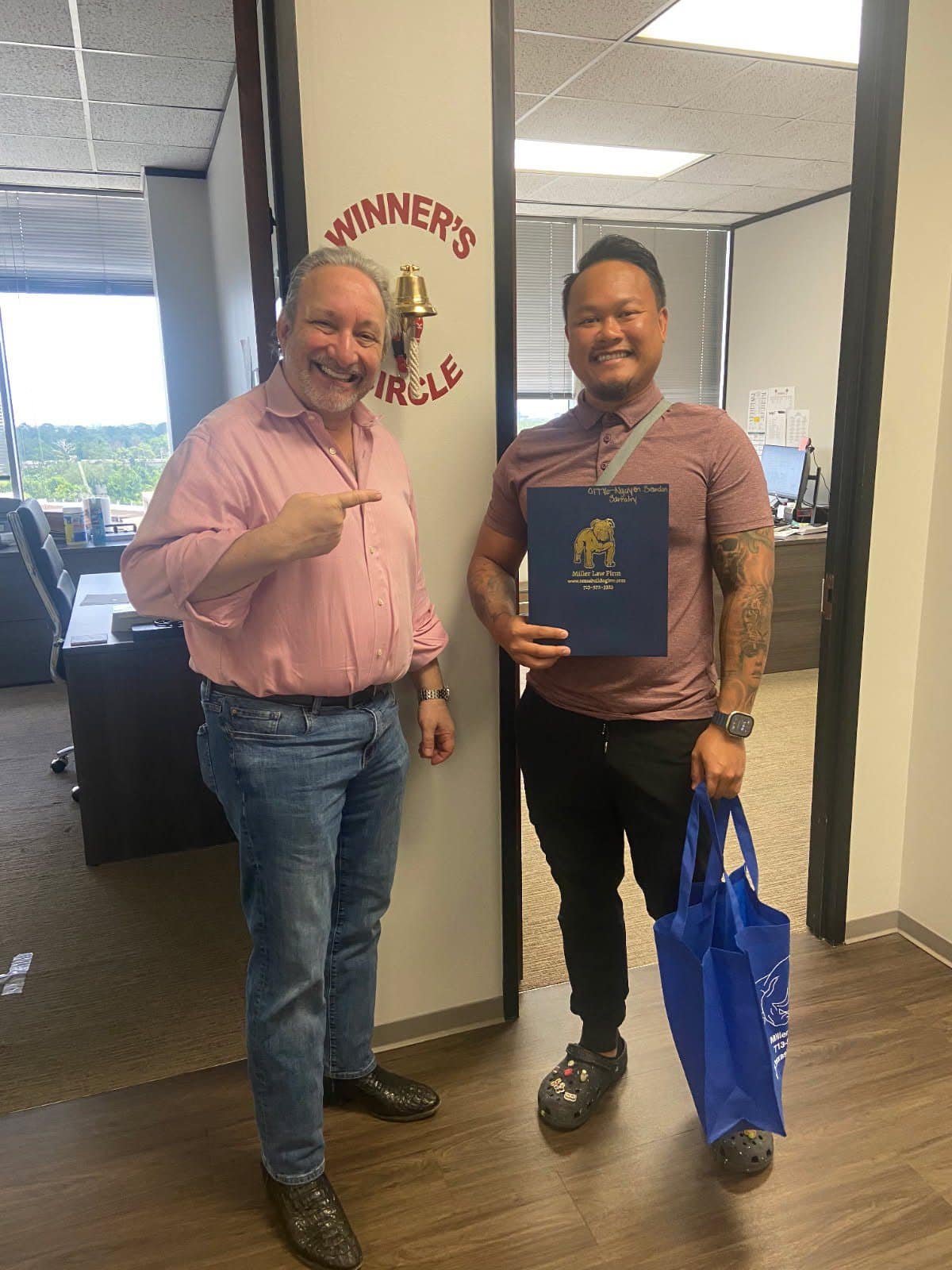 Happy Houston client poses with The Texas Bulldog after successful injury case.