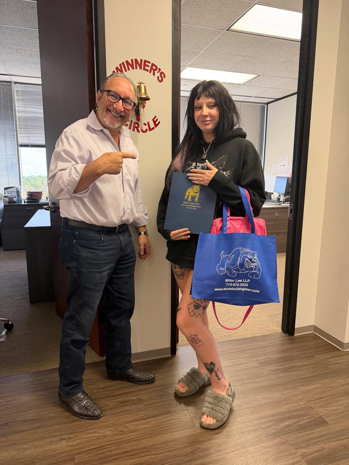 Smiling client ringing bell after accident settlement