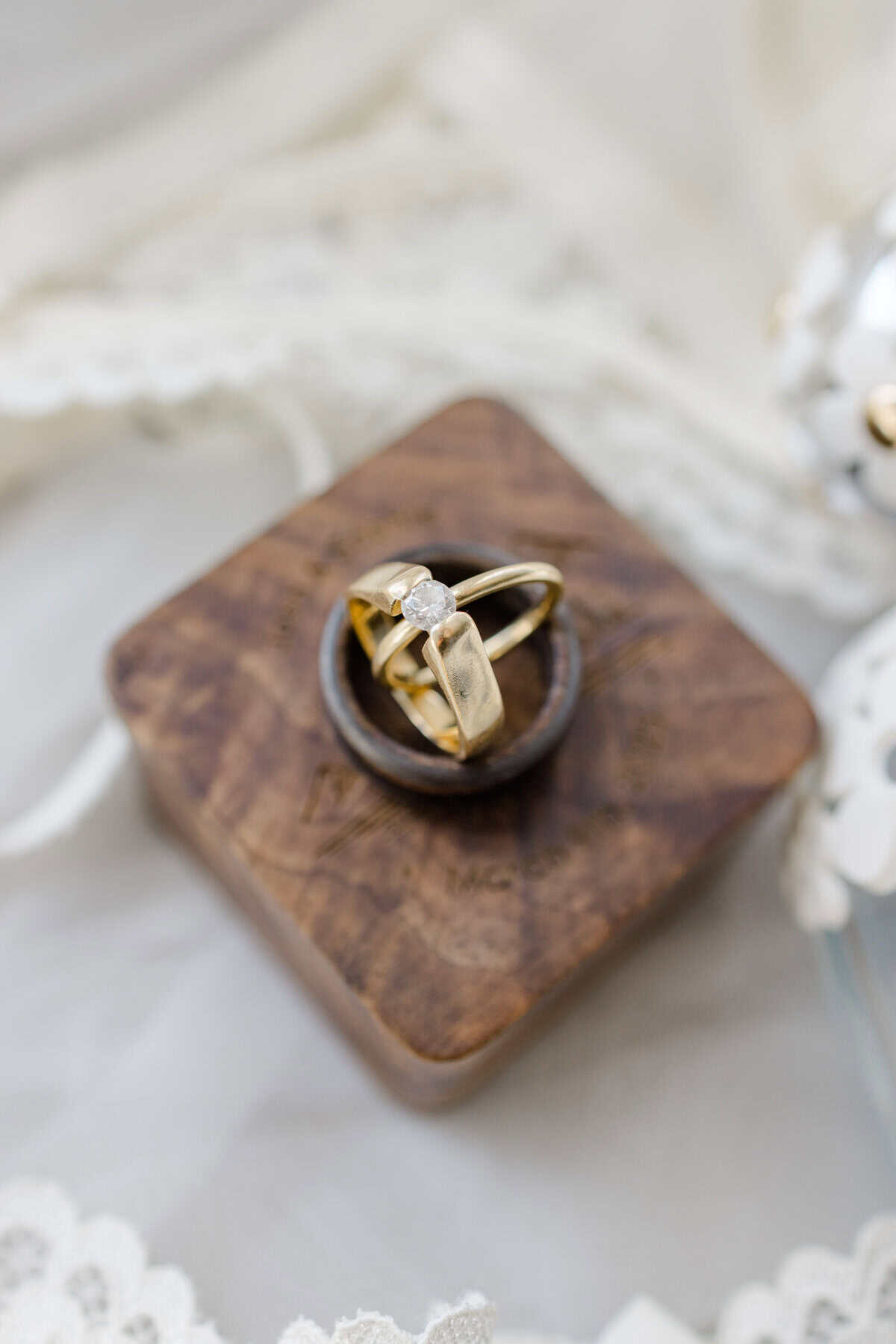 Wedding rings on a wooden block, a getting-ready detail from Sophie and Josh's Aquatopia wedding