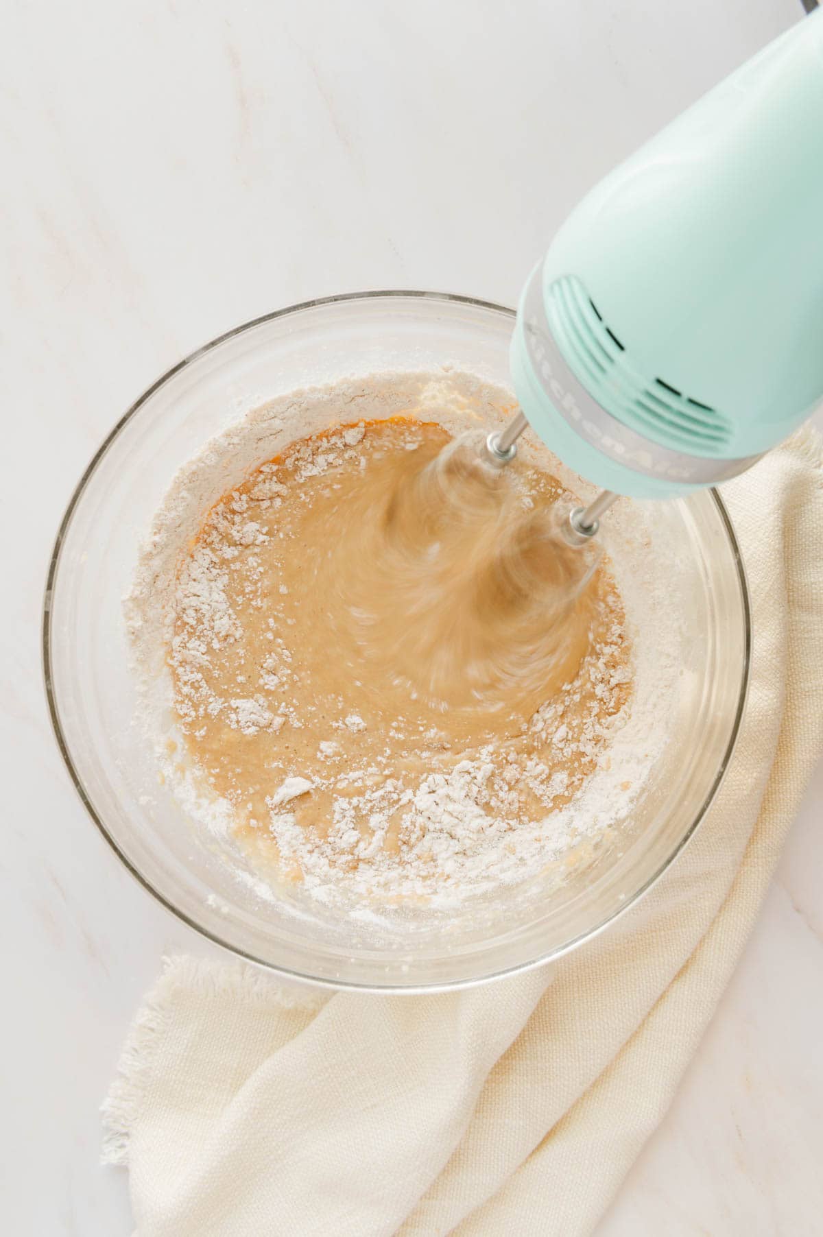 Dry ingredients being added to a mixing bowl for the chai cupcakes.