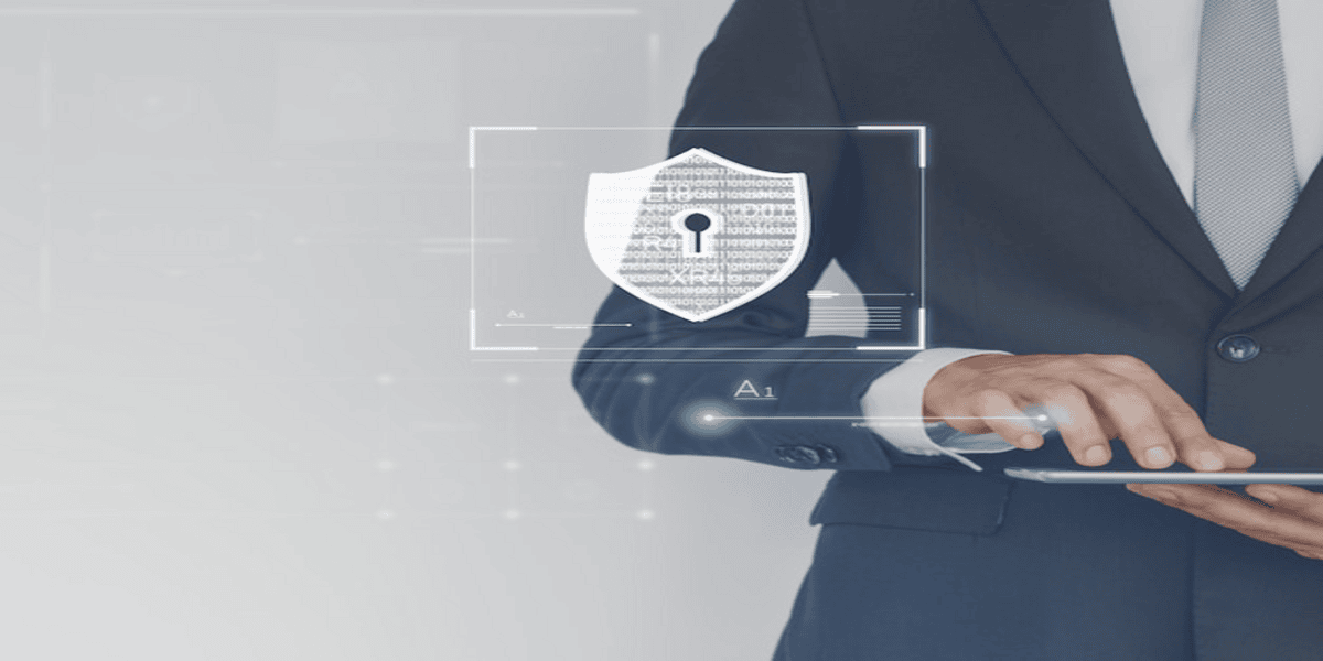 Business professional holding a digital tablet with a virtual security shield icon.