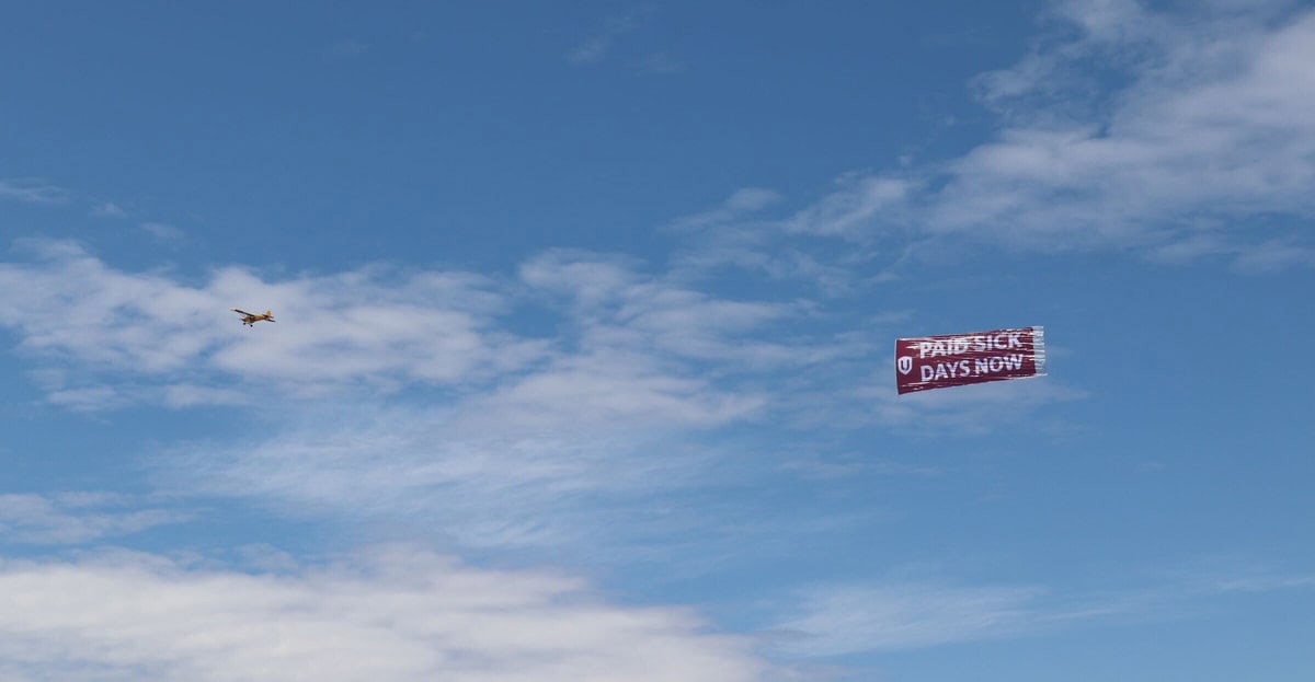 Unifor takes to Toronto skies with a bold PAID SICK DAYS NOW message for Premier Ford