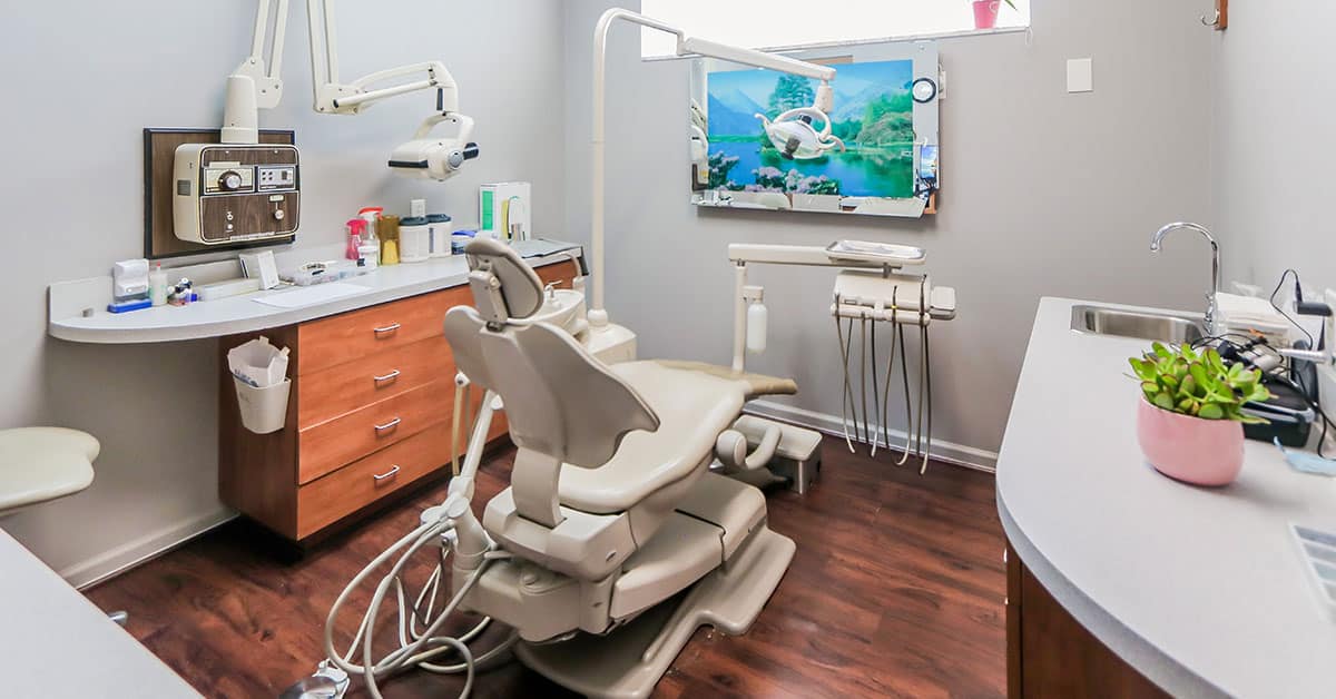 Dental operatory room with chair and equipment.