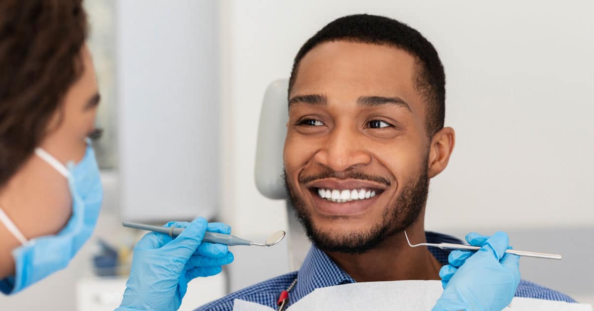 Gemini said Smiling man during a routine dental examination.