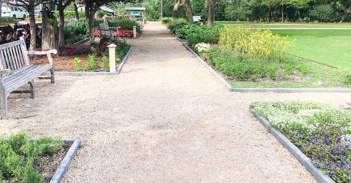 trail with bench and flowers