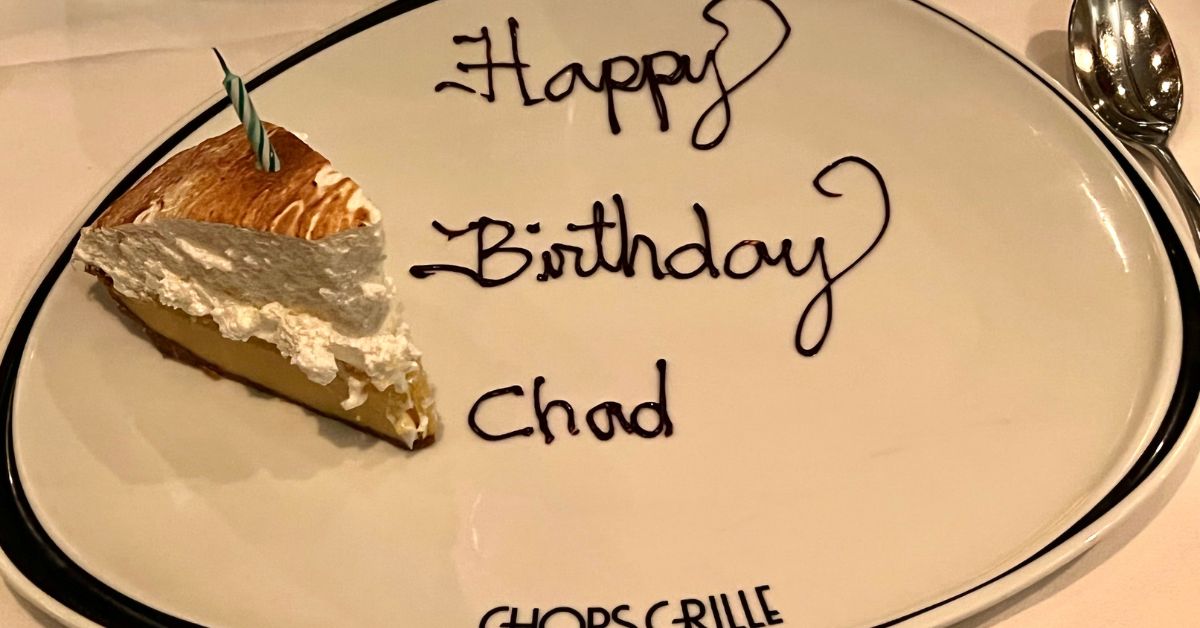 slice of cake with a candle and the words Happy Birthday Chad