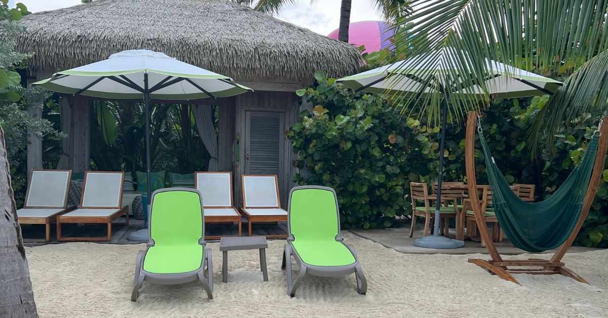 beach cabana with chairs, tables, and hammock