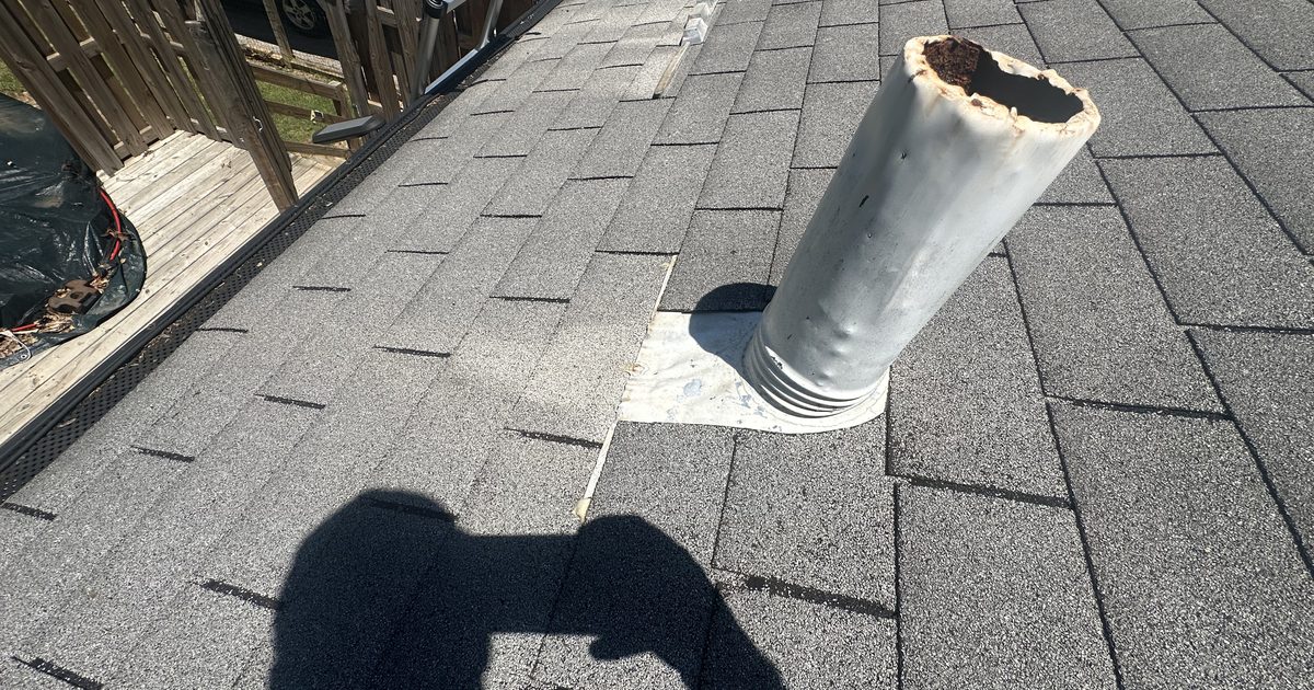 Cracked, deteriorated rubber pipe boot on an asphalt shingle roof - the most common source of roof leaks in DFW