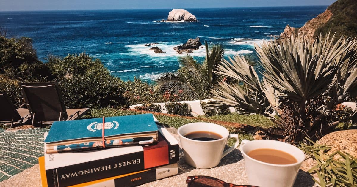 books and coffe on the table overlooking mazunte beach | view from best mazunte hotels