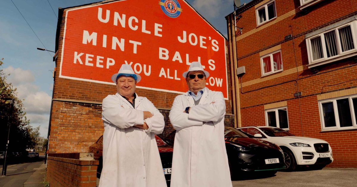 The owners of Uncle Joe’s Mint Balls in white coats outside their factory in Wigan