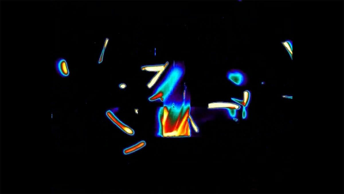 Thermal imaging of an end mill heating up as it cuts through metal with chips flying