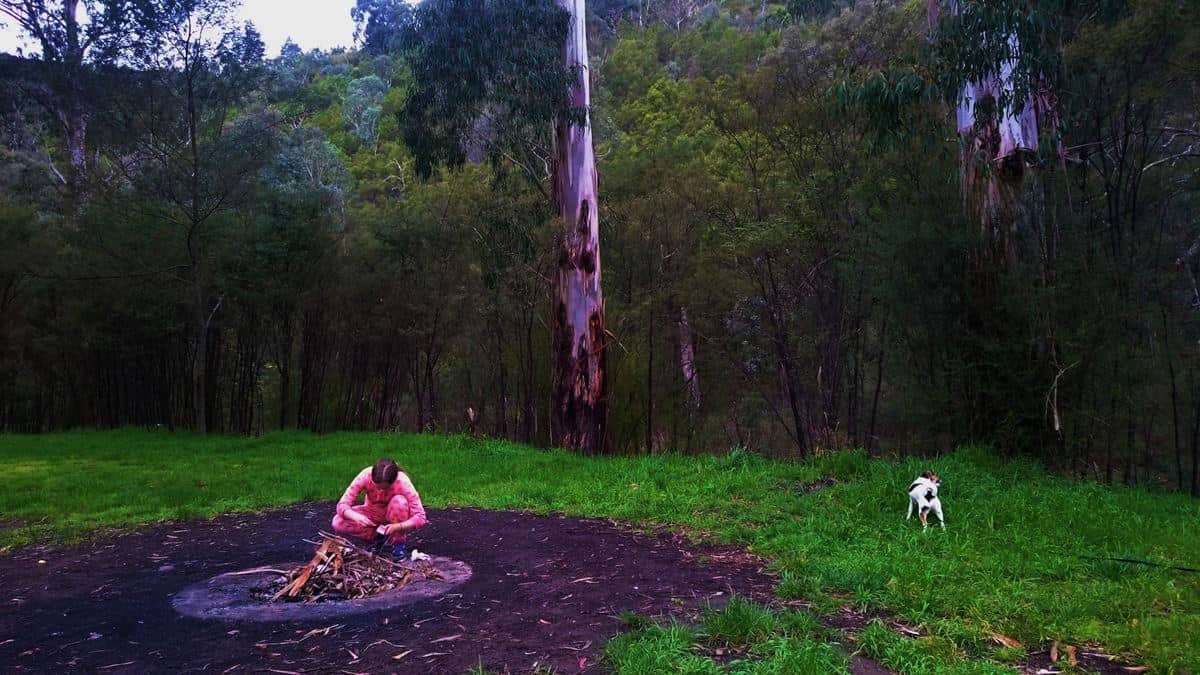 Out in her onesie, lighting the fire! Free Camping at Dargo, Victoria